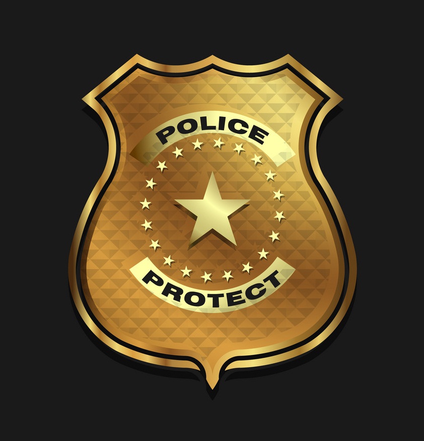 gold police badge on black background
